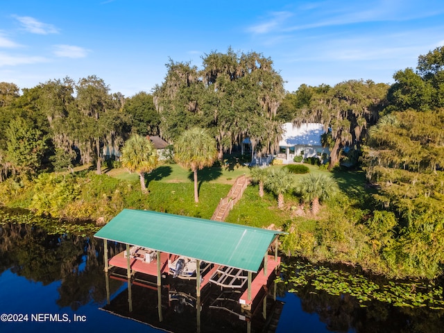 view of dock with a water view and a lawn