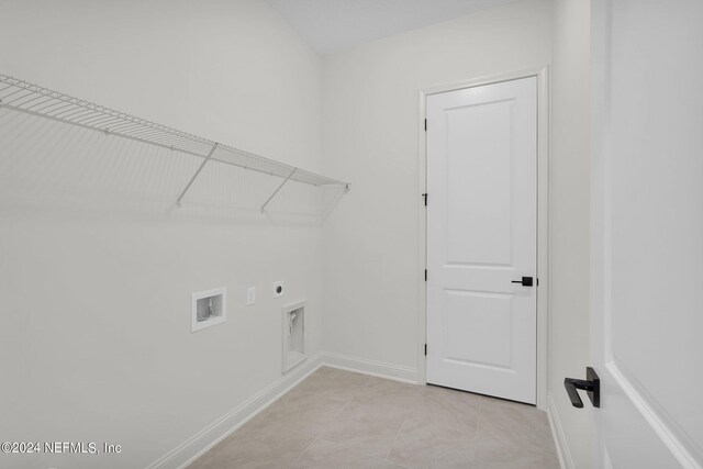 laundry area with hookup for a washing machine, hookup for an electric dryer, and light tile patterned flooring