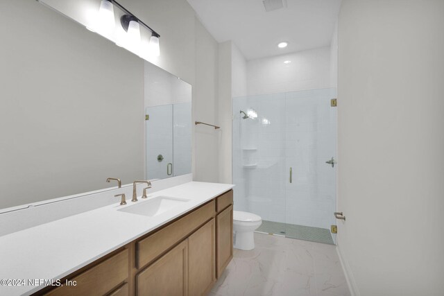 bathroom with vanity, an enclosed shower, and toilet