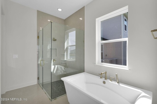 bathroom with tile patterned floors and plus walk in shower