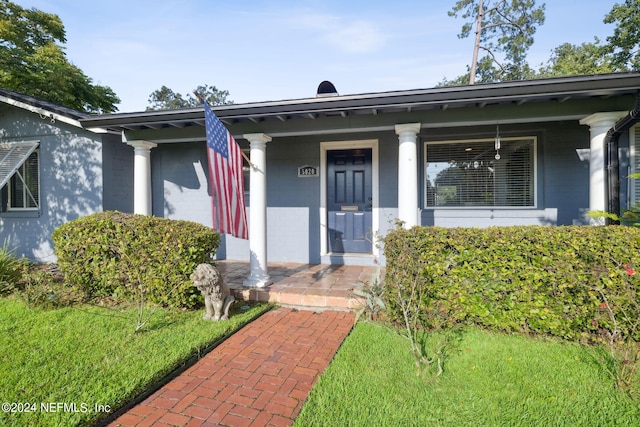 property entrance featuring covered porch