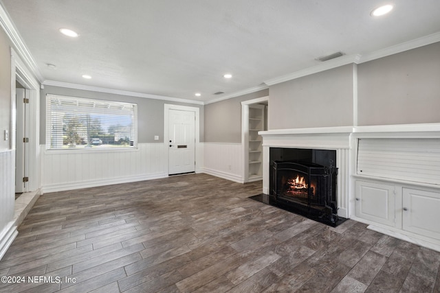 unfurnished living room with crown molding and dark wood-type flooring