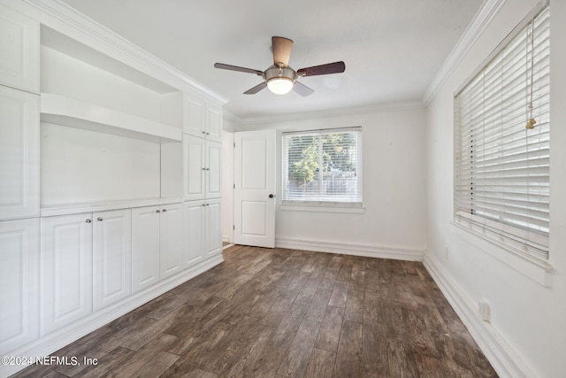 unfurnished room with crown molding, dark wood-type flooring, and ceiling fan