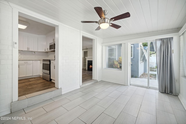 interior space with wood ceiling and ceiling fan