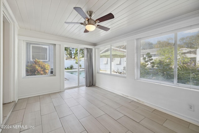 unfurnished sunroom with wood ceiling and ceiling fan