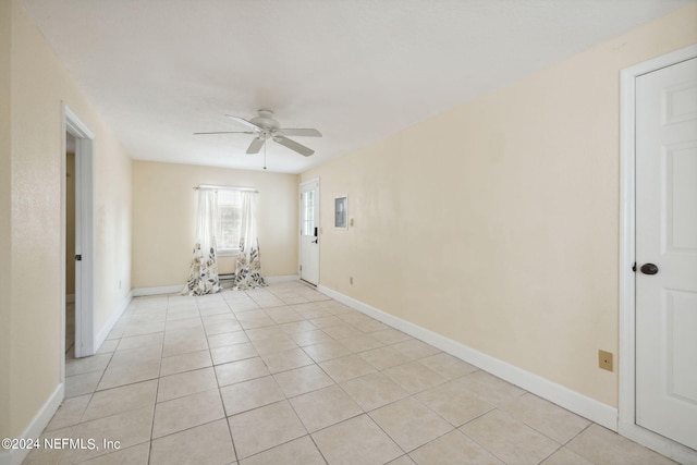 tiled empty room with ceiling fan