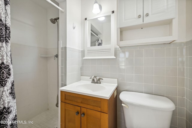 bathroom featuring vanity, curtained shower, toilet, and tile walls