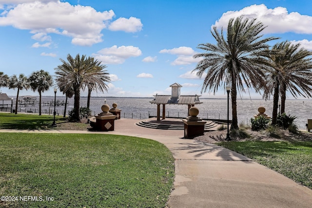 view of property's community featuring a water view and a yard