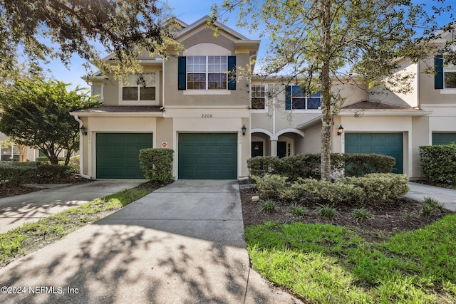 multi unit property featuring a garage