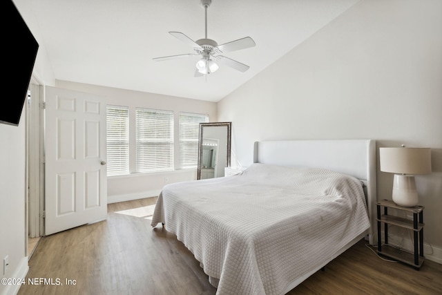 bedroom featuring wood-type flooring, vaulted ceiling, and ceiling fan