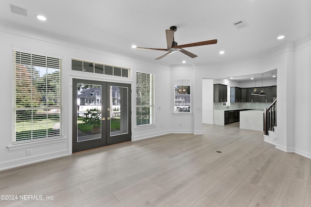 unfurnished living room with ornamental molding, french doors, light wood-type flooring, and ceiling fan