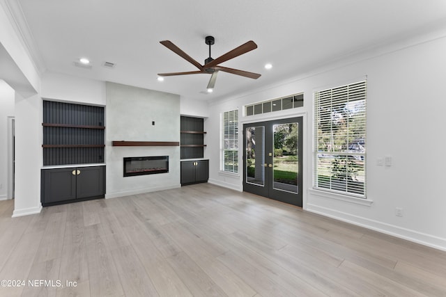 unfurnished living room with crown molding, french doors, light wood-type flooring, and ceiling fan