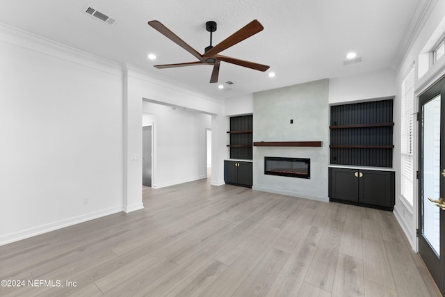 unfurnished living room with crown molding, light wood-type flooring, and ceiling fan