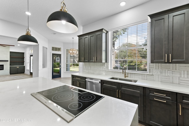 kitchen with dishwasher, decorative light fixtures, and plenty of natural light