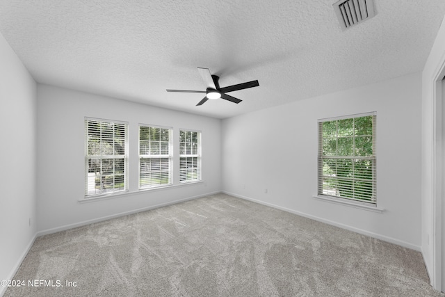 spare room with light carpet, a textured ceiling, and ceiling fan