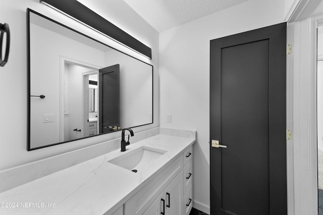 bathroom featuring vanity and a textured ceiling