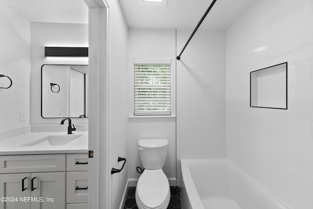 full bathroom with toilet, tiled shower / bath combo, vanity, and a textured ceiling