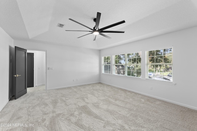 carpeted empty room with ceiling fan and a textured ceiling