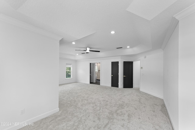 carpeted empty room with crown molding, a textured ceiling, and ceiling fan