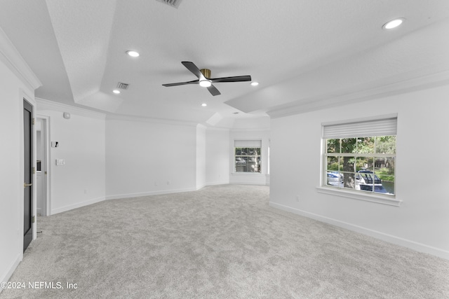 spare room with light carpet, crown molding, a textured ceiling, and ceiling fan