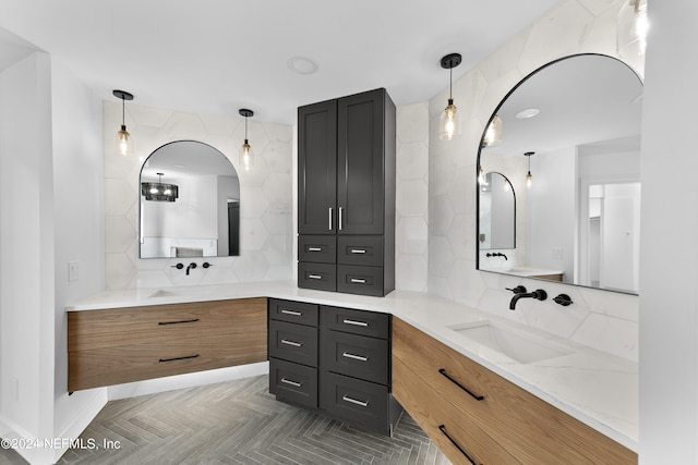 bathroom with vanity, parquet flooring, and backsplash