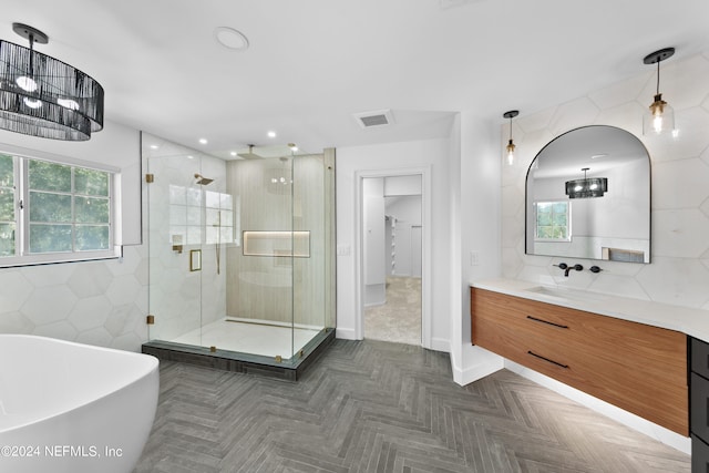 bathroom with vanity, decorative backsplash, and shower with separate bathtub