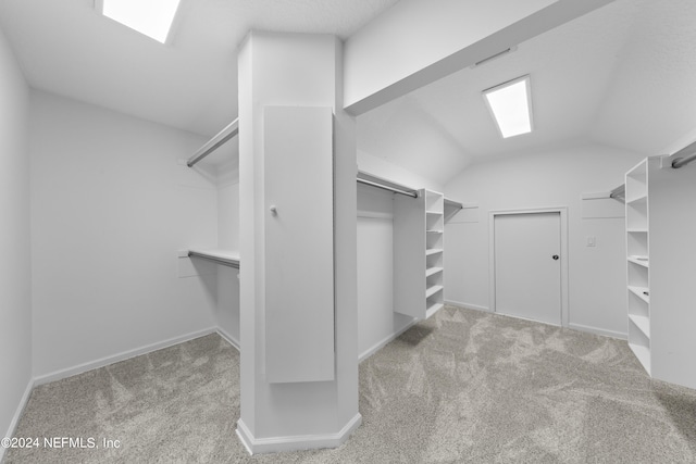 spacious closet with light carpet and lofted ceiling