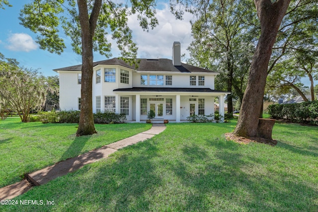 view of front of home with a front yard and covered porch