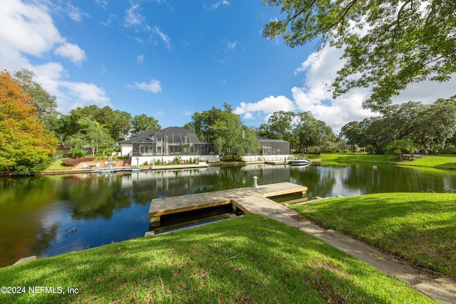 view of dock featuring a yard and a water view