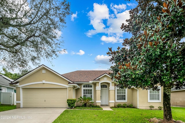 ranch-style house with a front yard, driveway, stucco siding, and an attached garage