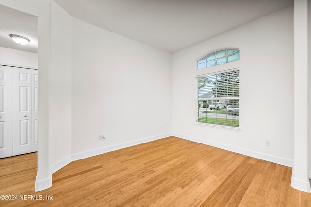 empty room featuring light wood-style floors and baseboards