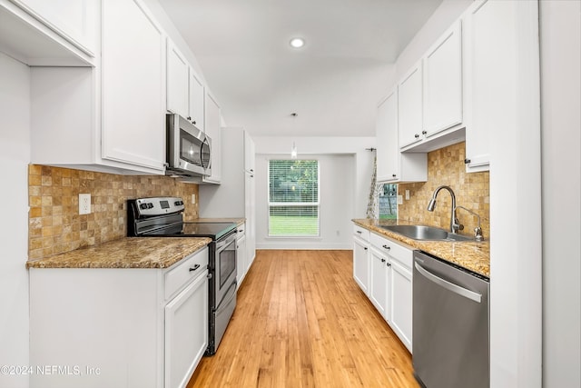kitchen featuring appliances with stainless steel finishes, a sink, and white cabinets