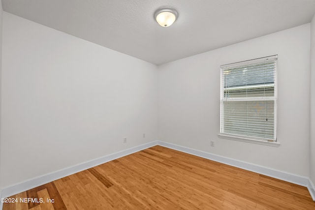 spare room featuring hardwood / wood-style flooring