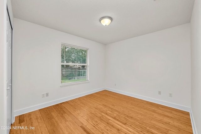 unfurnished room featuring light wood-type flooring and baseboards