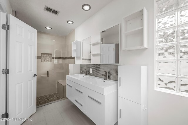bathroom featuring tasteful backsplash, vanity, recessed lighting, a shower stall, and visible vents