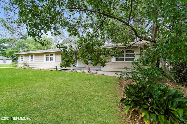 rear view of property featuring a yard