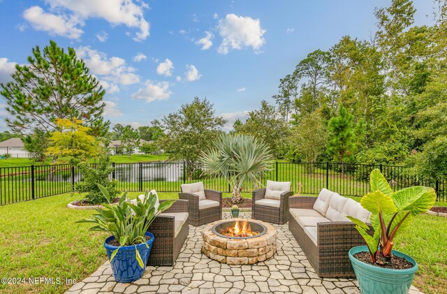 view of patio with an outdoor living space with a fire pit