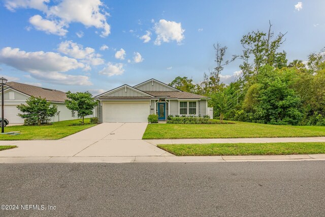 single story home with a garage and a front yard