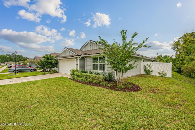 view of front of home with a front lawn and a garage