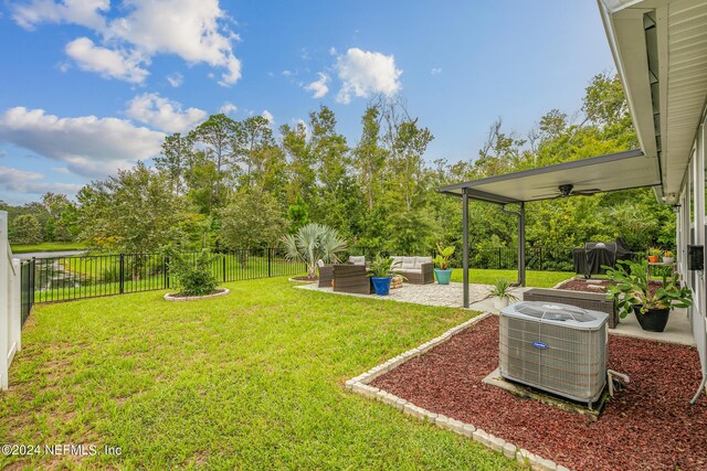 view of yard featuring outdoor lounge area, cooling unit, a patio area, and ceiling fan