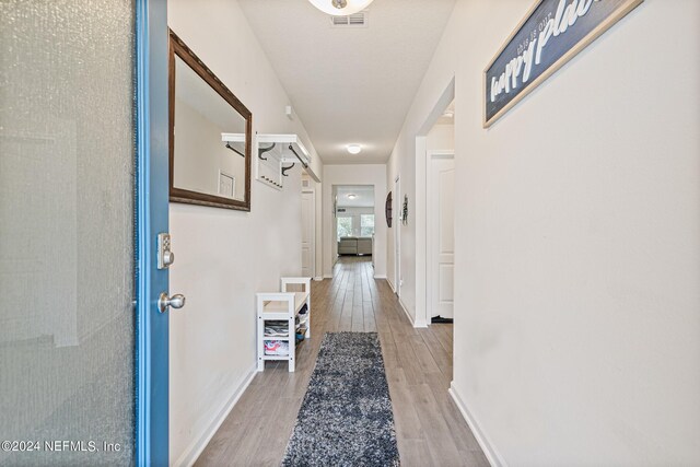 corridor featuring wood-type flooring