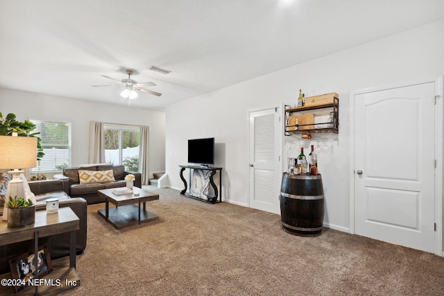 carpeted living room with ceiling fan