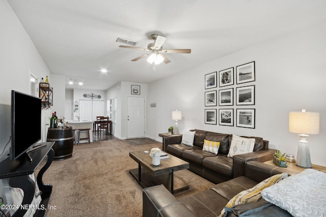 living room with ceiling fan and carpet floors