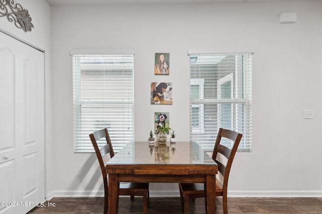 dining space featuring dark wood-type flooring and a wealth of natural light