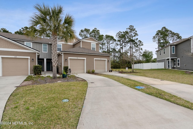 view of front of property with a front yard and a garage