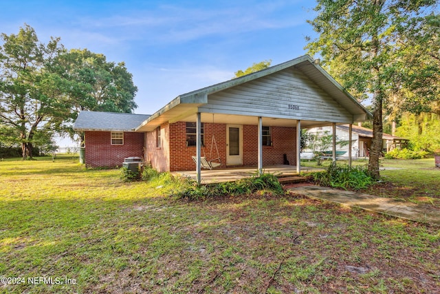 rear view of house featuring a lawn