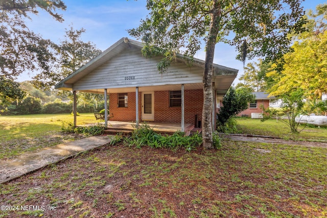 bungalow featuring a front lawn and a porch