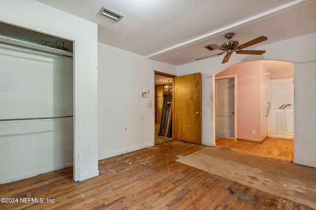 unfurnished bedroom featuring ceiling fan, hardwood / wood-style flooring, and ensuite bathroom