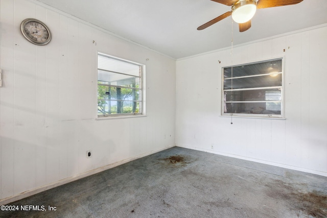 carpeted empty room featuring ceiling fan and ornamental molding