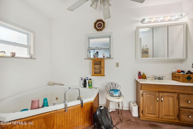 bathroom featuring ceiling fan, vanity, and a bathing tub